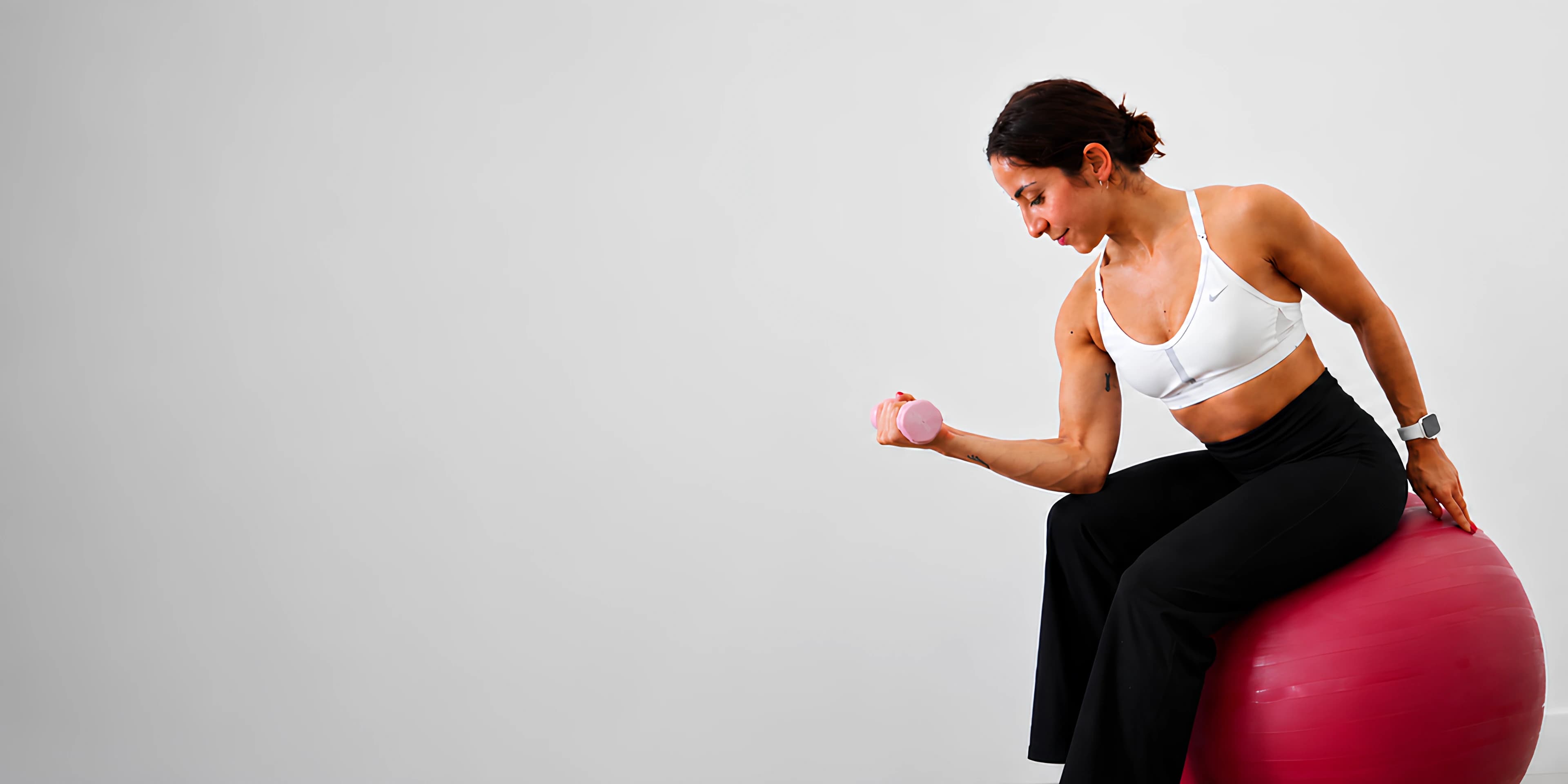 Sara Brigites training on a stability ball in the studio